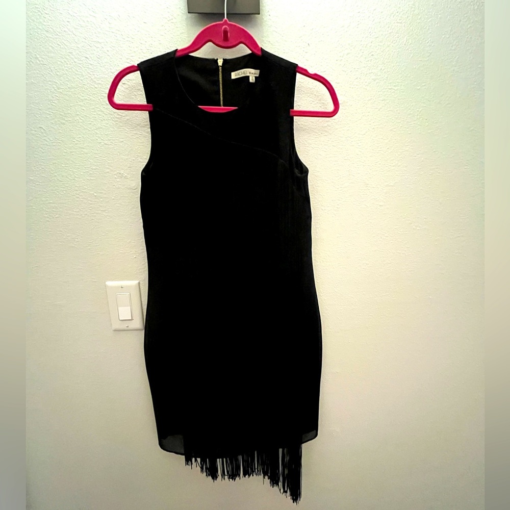 Sleeveless black fringe mini dress with zip up back. Fully lined.